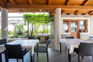 a patio with tables and chairs and a fireplace at Apartments and Rooms Ješelnik in Portorož