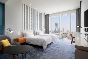a hotel room with a bed and a large window at Le Meridien Riyadh in Riyadh