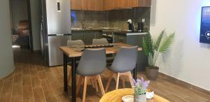 a kitchen with a table with chairs and a refrigerator at Olympus House in Litochoro