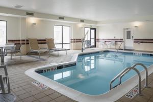 a pool in a hotel room with chairs and a table at SpringHill Suites Knoxville At Turkey Creek in Knoxville