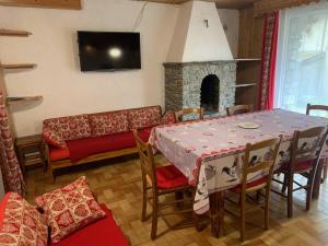a living room with a table and a couch at Le p'tit coin montagne 3 in Bonneval-sur-Arc