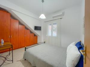 a bedroom with a bed and orange cabinets at Artemis Bakerys House 2 in Adamas