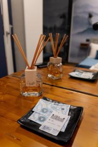 a table with two glass jars with sticks in them at B&Business - Fibra Ultraveloce, Angolo Fitness, SmartWorking in Cosenza +23 photos