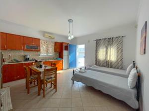 a bedroom with a bed and a table in a kitchen at Artemis Bakerys House 2 in Adamas
