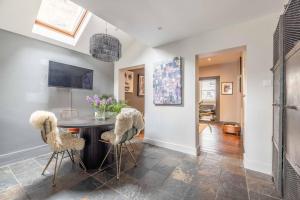 a dining room with a table and chairs at Stylish 2-Bed House With Office And Private Garden in Windsor