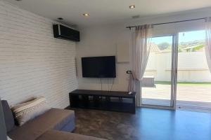 a living room with a couch and a flat screen tv at Calme, Confortable, Central in Sainte-Maxime