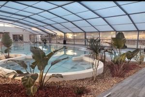 a large swimming pool with a glass ceiling at Calme, Confortable, Central in Sainte-Maxime