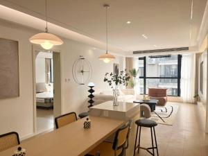 a kitchen and living room with a table and chairs at Three Bedroom Apartment near Xintiandi in Shanghai