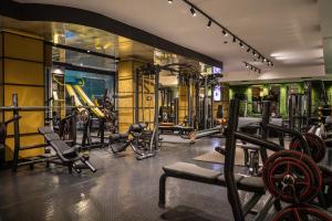 a gym with several treadmills and exercise bikes at ADEO HOTEL Sport & SPA in Ruse