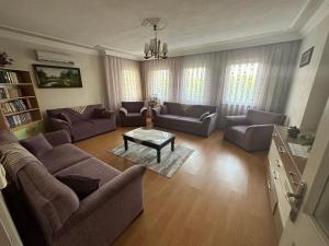 a living room with couches and a coffee table at Aysel Villa in Ortaca