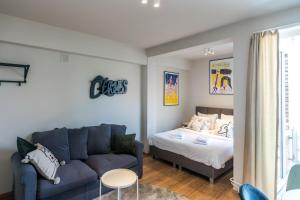 a living room with a couch and a bed at Japie rooms - in the heart of Antwerp in Antwerp