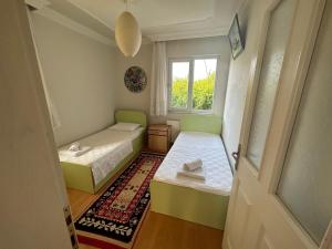 a small room with two beds and a window at Aysel Villa in Ortaca +46 photos