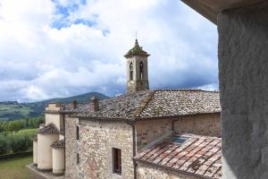 a building with a clock tower on top of it at Pieve Aldina Relais & Ch&acirc;teaux in Radda in Chianti