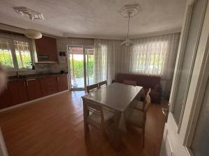a kitchen and dining room with a table and chairs at Aysel Villa in Ortaca
