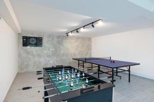 two ping pong tables in a room with two tables at Seaside Escape Mielenko by Noclegi Renters in Mielenko