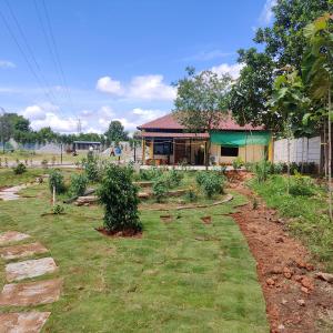 a garden in front of a house at Encanto Farmstay in Mysore
