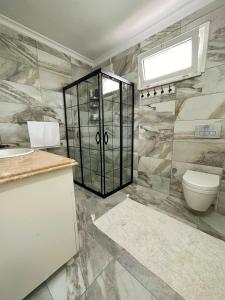 La salle de bains est pourvue d'une douche, de toilettes et d'un lavabo. dans l'établissement COUNTRY HOME, à Trabzon