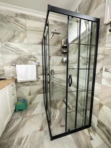 a shower with a glass door in a bathroom at COUNTRY HOME in Trabzon