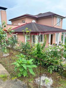COUNTRY HOME في طرابزون: منزل وردي أمامه سياج