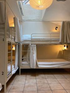 a room with three bunk beds in a room at Nomad Cave in Stockholm