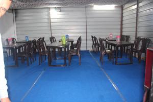 a group of tables and chairs in a room at DJSR Resort in Barkot