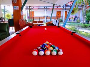 a red pool table with four balls on it at MS Hotel Sriracha in Si Racha