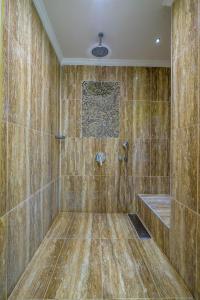 a bathroom with a shower with a tub at Grand Gocek Hotel in Göcek