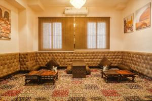 a waiting room with a large leather couch at FabHotel Double Tree in Hyderabad