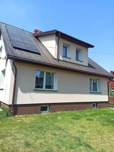 a house with solar panels on top of it at Apartament Pod Orzechem in Augustów