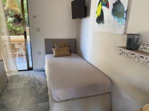 a bench in a room with a tv on the wall at Aelia Houses in Agia Marina Aegina