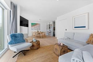 a living room with a couch and a chair at Seaflow-Holiday appartment with frontal sea view in Oostduinkerke