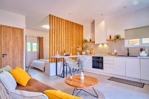 a kitchen and living room with a couch and a table at Limosa Beach House Corfu in Agios Georgios Pagon +27 photos
