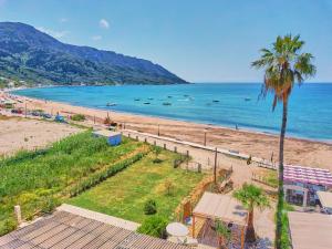 a view of a beach with boats in the water at Limosa Beach House Corfu in Agios Georgios Pagon