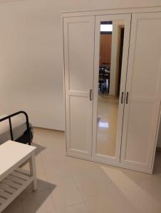 a white cabinet with a door in a room at CASA JO in Bari