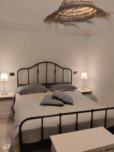 a bedroom with a bed with two tables and two lamps at CASA JO in Bari