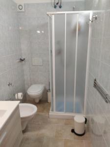 a bathroom with a shower and a toilet and a sink at CASA JO in Bari