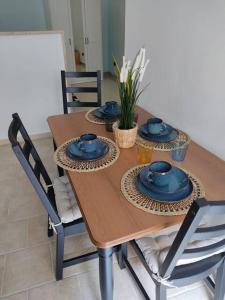a wooden table with blue dishes on top of it at CASA JO in Bari