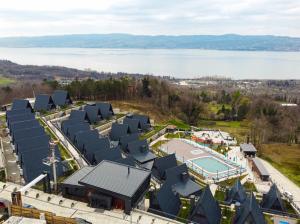 an aerial view of a resort with a pool and a lake at World DREAMS Forest in Sapanca