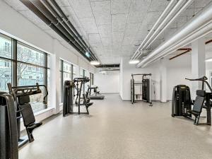 a gym with several treadmills and elliptical machines at The Bohemian Courtyard Studios in Vienna