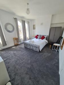 a bedroom with a bed and a chair in it at Three bedroom House in London