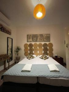 a bedroom with a large bed with towels on it at Garden Place Alojamento Local in Viseu