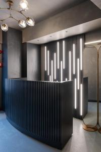 a lobby with a black and white wall with lights at Persona Hotel Galata in Istanbul