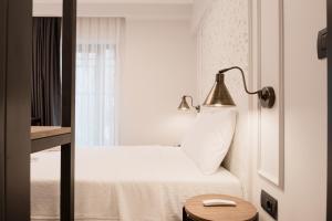 a hotel room with a bed with a lamp and a window at Persona Hotel Galata in Istanbul
