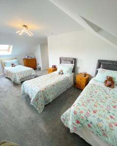 a bedroom with two beds with teddy bears on them at Ardbrin Lodge in Dunadry