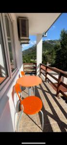 an orange table and chairs on a balcony at Motel and Restaurant Odušak in Drežnjak