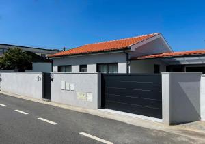 a house with a black garage door on a street at House 9 Guimarães in Guimarães