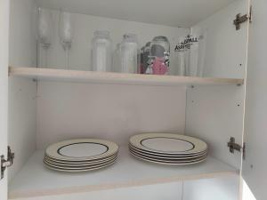 two stacks of plates sitting on shelves in a pantry at The Dairy in Pershore
