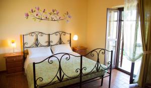 a bedroom with a bed with a wrought iron headboard at Agriturismo Terralieta in Roseto degli Abruzzi