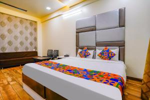 a bedroom with a large bed in a room at FabHotel Tanishq in Sinnar