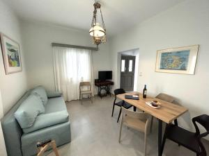 a living room with a couch and a table at Villa DALI Danae in Fira